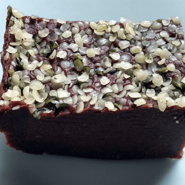 Piece of date-walnut fudge with hemp seeds.