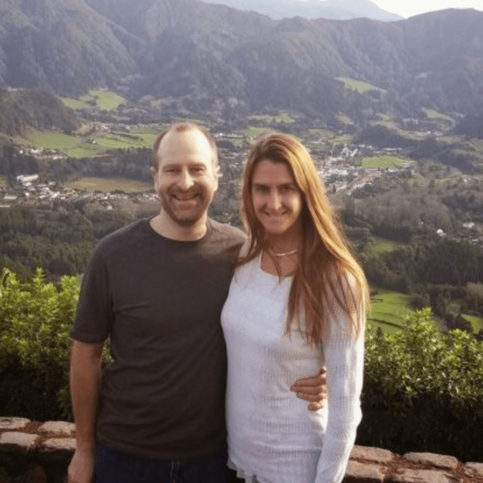 Two people in the Azores with beautiful background scenery.
