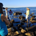 People looking for seaweed at the ocean.