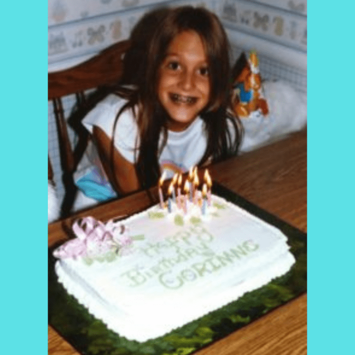 Girl with braces smiling with her birthday cake.